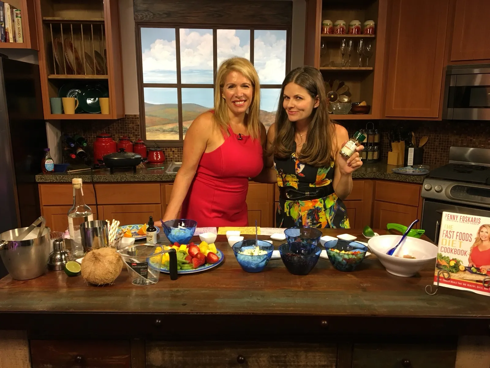 Penny Foskaris on a TV cooking show with her cookbook